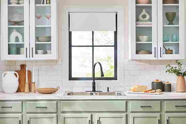 a kitchen with white cabinets and a sink